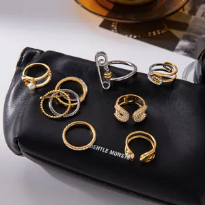 Set of elegant gold and silver stainless steel rings featuring paperclip and pearl designs