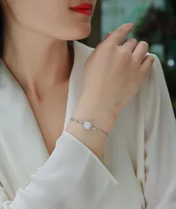 Close-up of an elegant sterling silver Moissanite bracelet on a woman's wrist detail