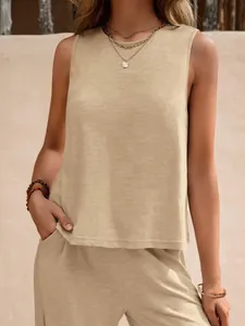 Detailed macro view showing the texture of beige sleeveless cotton top and matching pants