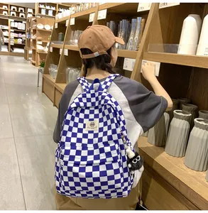 Detailed lifestyle view of a blue and white checkered backpack in a store setting.