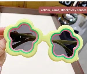 Detailed close-up view of cute yellow flower-shaped children sunglasses with dark lenses.