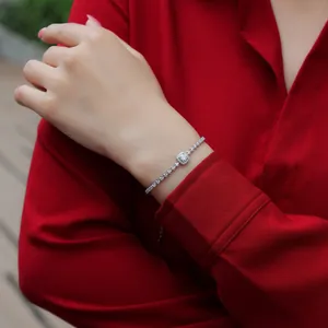 Detailed close-up of a sparkling sterling silver moissanite bracelet on a woman's wrist