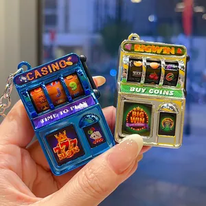 Close-up of mini slot machine keychains in vibrant blue and yellow electroplated colors