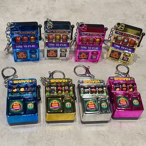Detail showing eight colorful mini slot machine keychains on a textured background.