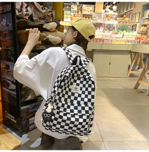 Stylish vintage black and white checkered backpack worn by a girl in a toy shop