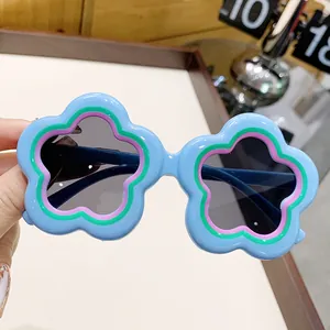 Adorable light blue flower-shaped sunglasses for kids with protective dark UV lenses