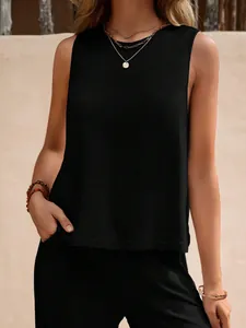 Detail of black sleeveless two-piece set with relaxed round neck cotton top