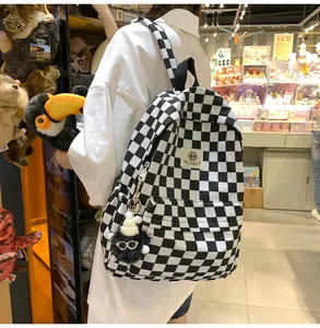 Stylish black and white checkerboard canvas backpack for school or casual daily travel