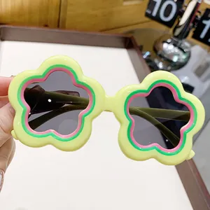 Cute flower-shaped sunglasses for kids with yellow frames and dark UV protection lenses.