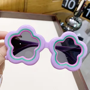 Purple flower-shaped children's sunglasses with dark lenses for UV protection