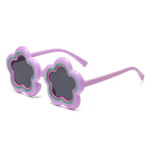 Cute purple flower-shaped sunglasses for kids with green accents and dark grey lenses