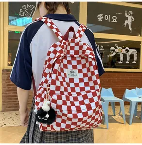Red and white checkered retro backpack for students shown in a casual lifestyle setting