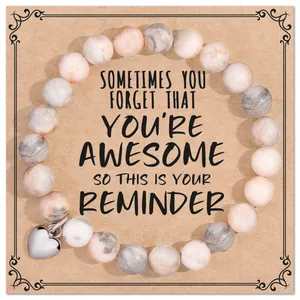 Handmade natural pink zebra stone beaded bracelet with heart charm on gift card