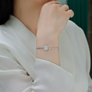 Close-up of elegant sterling silver moissanite stone bracelet worn on a female wrist