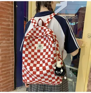 Detail of red and white checkered backpack worn by a student in a street setting