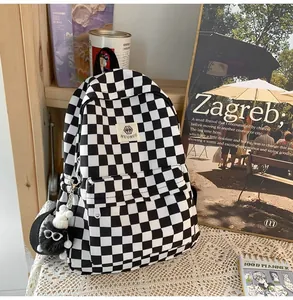 Close-up of a retro black and white checkerboard school backpack for students
