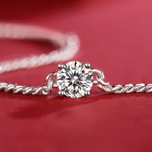 Close-up detail of a silver moissanite bracelet with brilliant round-cut center stone.