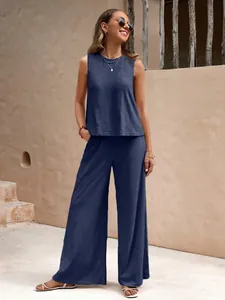 Full-body view of a stylish women's navy blue cotton two-piece set with wide-leg pants.