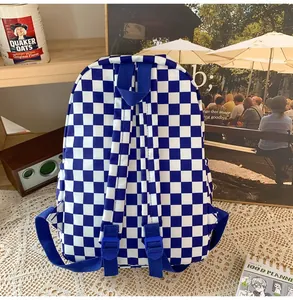Back view of a retro blue and white checkered backpack with adjustable padded straps