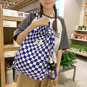 Vintage blue and white checkered backpack schoolbag with cute black pom-pom keychain for women