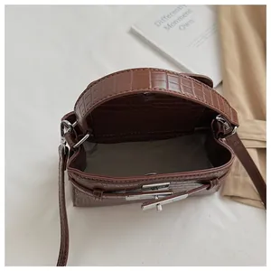Top view showing the interior of a brown croco-patterned Kelly style handbag with lock