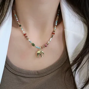 Detailed view of a colorful natural stone beaded necklace with a gold elephant pendant.