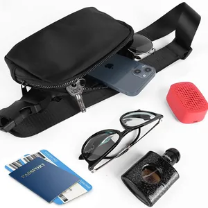Black waterproof nylon waist bag showing storage capacity with travel accessories