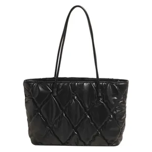 Stylish large black quilted puffer tote bag perfect for winter fashion and commuting