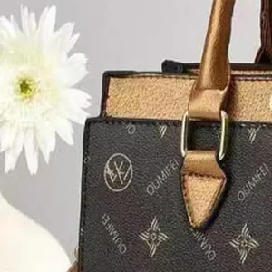 Detailed close-up showing the monogram pattern of an elegant OUMIFEI women tote bag