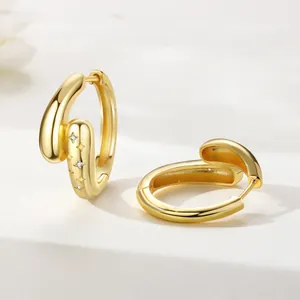 Detail view of 18K gold plated hoop earrings with engraved stars and zircon stones
