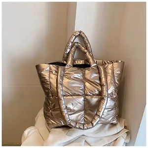 Detailed macro view of the metallic champagne gold quilted puffer tote bag texture