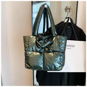 Close-up of a metallic green quilted puffer tote bag hanging in a stylish fashion display