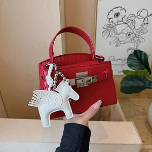 Fashionable red crocodile pattern Kelly handbag with a cute white Pegasus charm for women