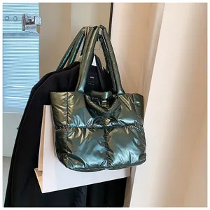 Metallic green quilted puffer tote bag shown in a stylish winter fashion setting