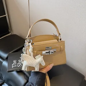 Elegant beige crocodile embossed Kelly handbag with silver lock and white Pegasus charm