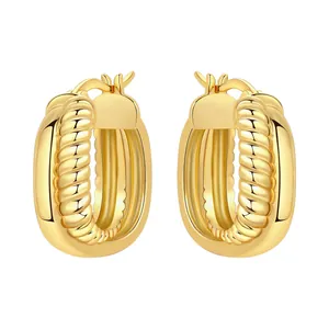 Close-up of gold-plated chunky hoop earrings with textured croissant rope design