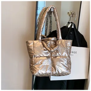 Large metallic puffer tote bag hanging in a stylish dressing room setting