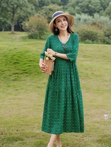 Full-length outdoor detail view of elegant green patterned cotton silk dress on model