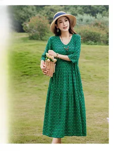 Full-length outdoor detail view of elegant green patterned cotton silk dress on model