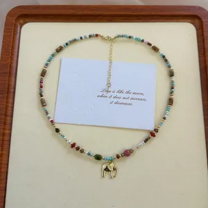 Handmade natural stone beaded necklace with a golden lucky elephant charm pendant.