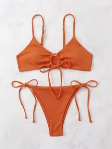 Sexy orange ribbed bikini set featuring a front ring tie detail and side-tie triangle bottoms