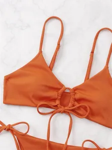 Detail of burnt orange ribbed bikini top with drawstring and adjustable straps