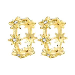 Detailed macro view of 18K gold plated eight-pointed star hoop earrings with stones