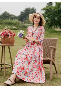 Elegant cotton silk floral maxi dress for summer shown in a scenic garden setting