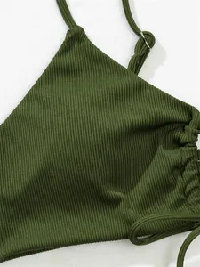 Detailed close-up of olive green ribbed bikini fabric showing texture and drawstring detail