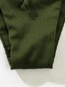 Detailed macro shot of dark green ribbed fabric and drawstring for a bikini set