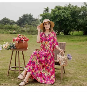 Detail of vibrant floral print cotton silk summer maxi dress for beach leisure