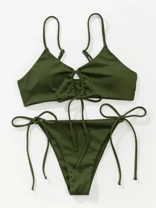 Detailed view of a stylish olive green ribbed drawstring bikini set with side ties.