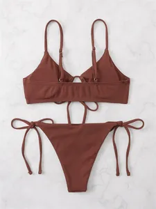Detailed view of women's solid terracotta ribbed triangle bikini set with drawstrings.