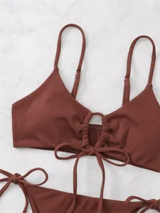 Close-up detail of brown ribbed triangle bikini top featuring center drawstring and bow